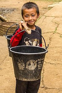 The Water Carrier in Hmong Village in Laos