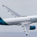 Emerald Airlines aircraft flying through the grey sky.
