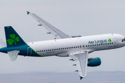 Emerald Airlines aircraft flying through the grey sky.