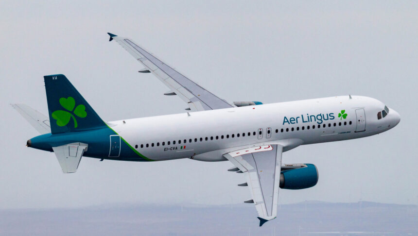 Emerald Airlines aircraft flying through the grey sky.