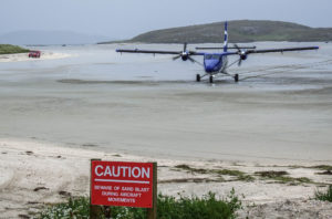 A plane landing on the sand runway at Barra Airport 