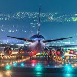 Plane at an unusual angle before take off on an illuminated runway
