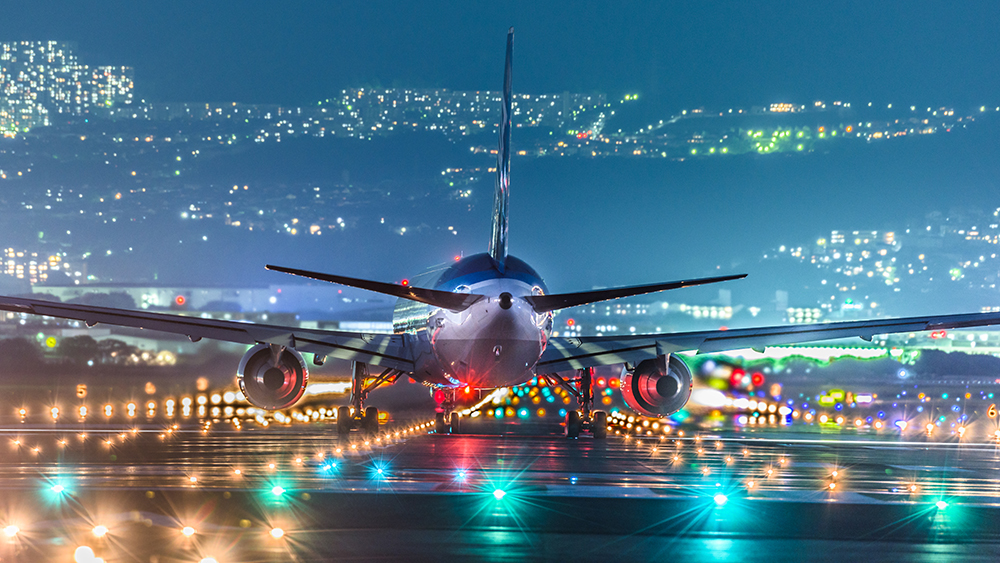 Plane at an unusual angle before take off on an illuminated runway