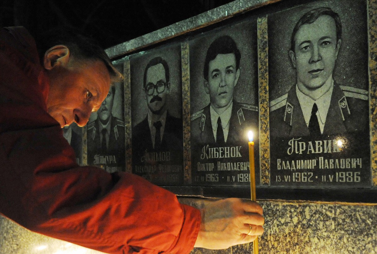 Man pays respect to the hero's of Chernobyl by lighting a candle at the Chernobyl victims' monument in Slavutich