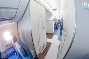 Passage on a passenger plane next to the toilet in economy class
