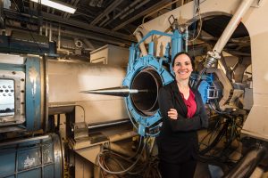 Woman stands next to hypersonic aircraft engine 