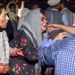 Wounded women arrive at a hospital for treatment after two blasts went off outside the airport in Kabul. Third blast and up to 60 dead