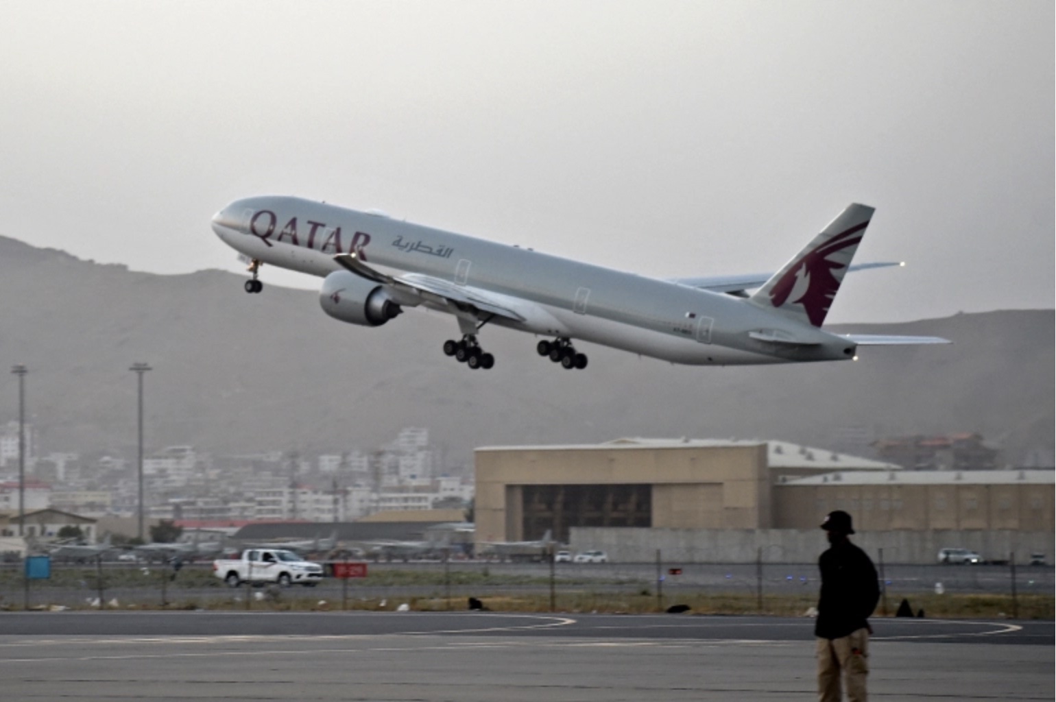 Showing Qatar Airways plane departing