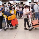 Passengers queue at Shanghai airport