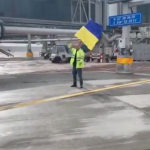 Israeli Airport Worker Waives Ukrainian Flag in Front of Russian Plane