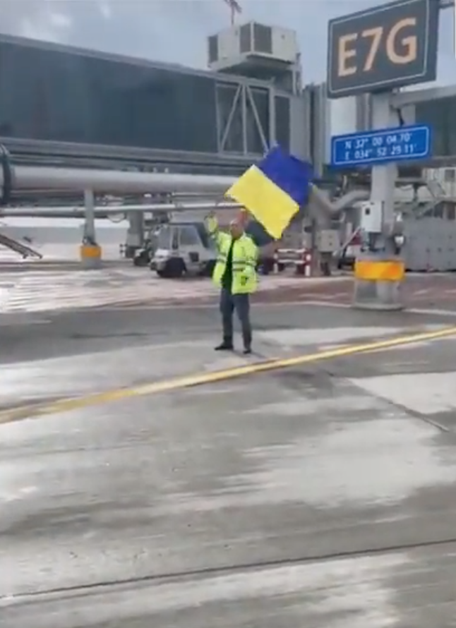 Israeli Airport Worker Waives Ukrainian Flag in Front of Russian Plane