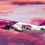 Wizz air plane in pink clouds