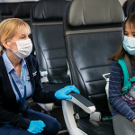 Masked Airline crew with masked child