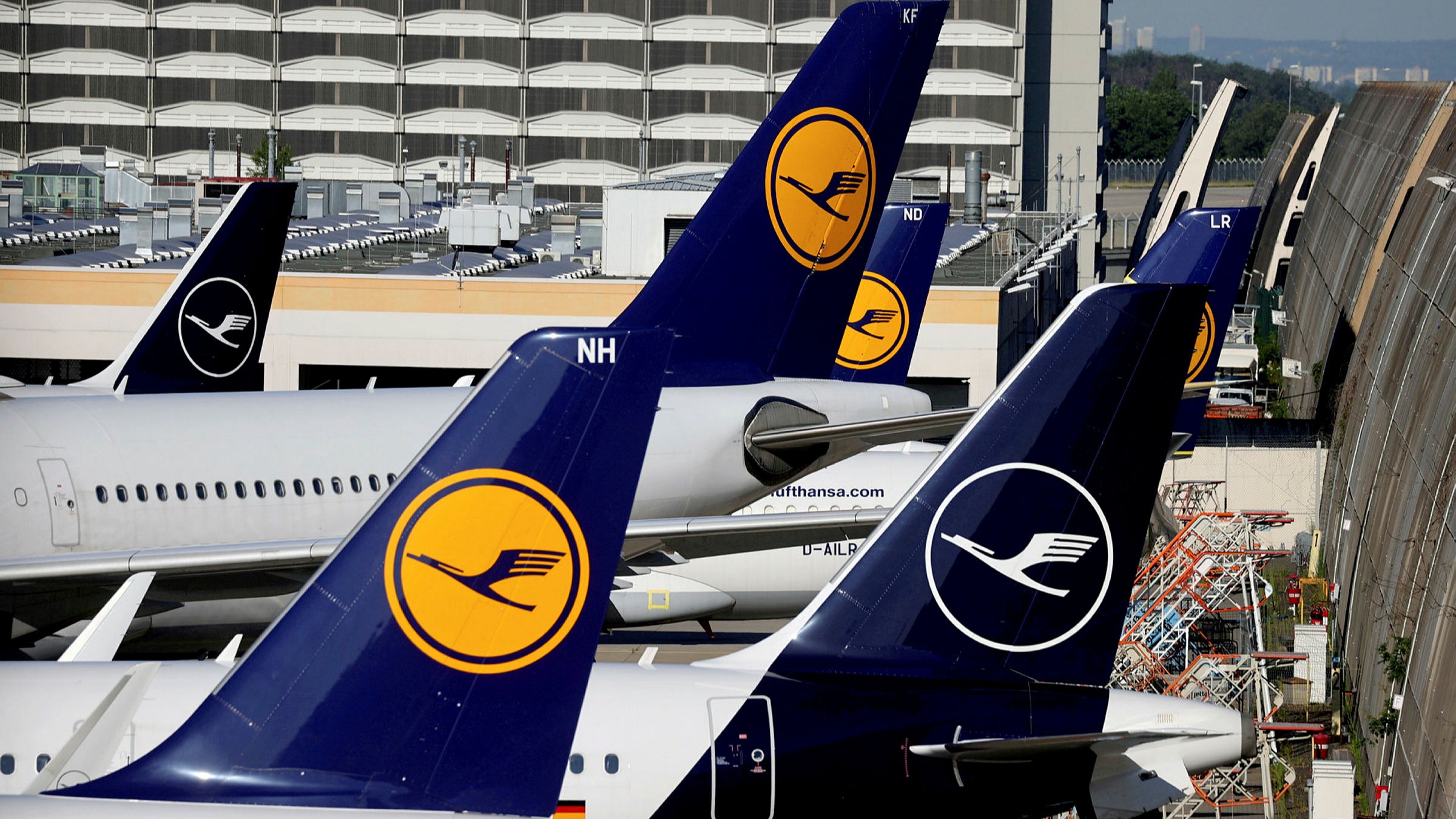 Four Lufthansa planes in a row signalling the aircraft will continue to operate and will not be overcome by strikes