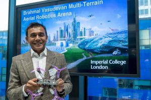 Brahmal Vasudevan in front of the the Brahmal Vasudevan Multi-Terrain Aerial Robotics Arena