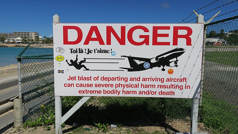Princess Juliana Airport Sint Maartin riding the Fence warning sign