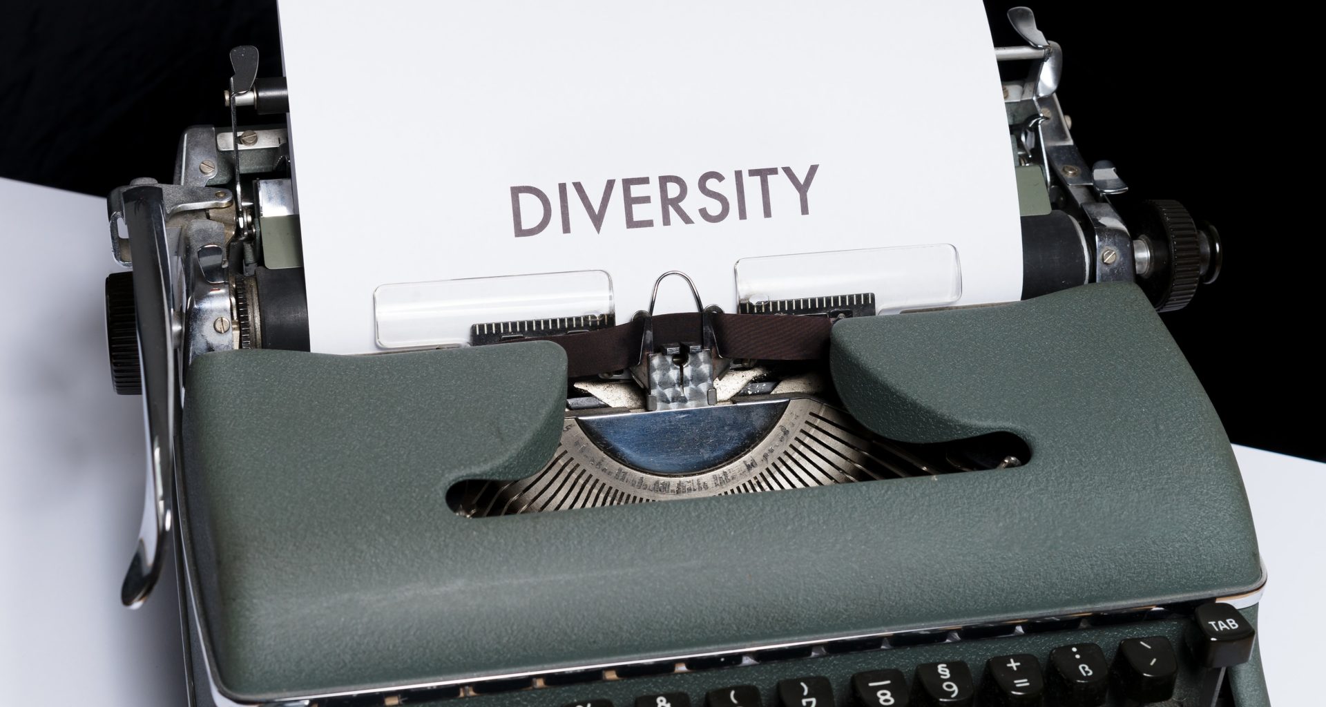 Image of a piece of paper coming out of a Typewriter with the words "DIVERSITY"