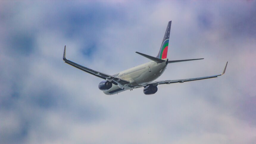 a large jetliner flying through a cloudy blue sky