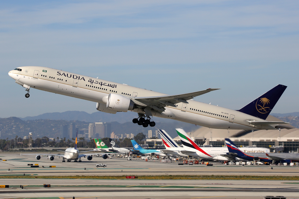  A Saudia Boeing 777-300 with the registration HZ-AK19 takes off from Los Angeles International Airport (LAX) in the USA. Saudia is the flag carrier airline of Saudi Arabia with its headquarters in Jeddah.