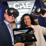 A lady and man with headsets and an electronic tablet