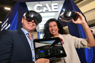 A lady and man with headsets and an electronic tablet