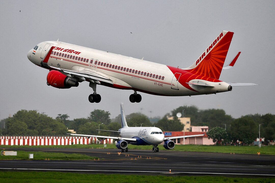 A red and white plane takes off from the runway