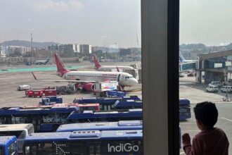 A boy looks at aircraft in an airport