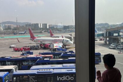 A boy looks at aircraft in an airport