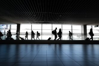 Passengers walking through an airport.