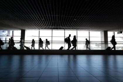 Passengers walking through an airport.