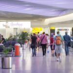 People walk through an airport