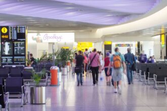 People walk through an airport