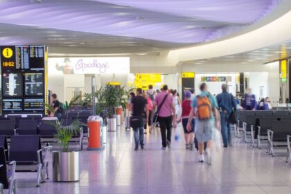 People walk through an airport