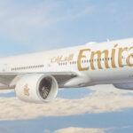 Emirates airplane over clouds