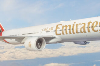 Emirates airplane over clouds
