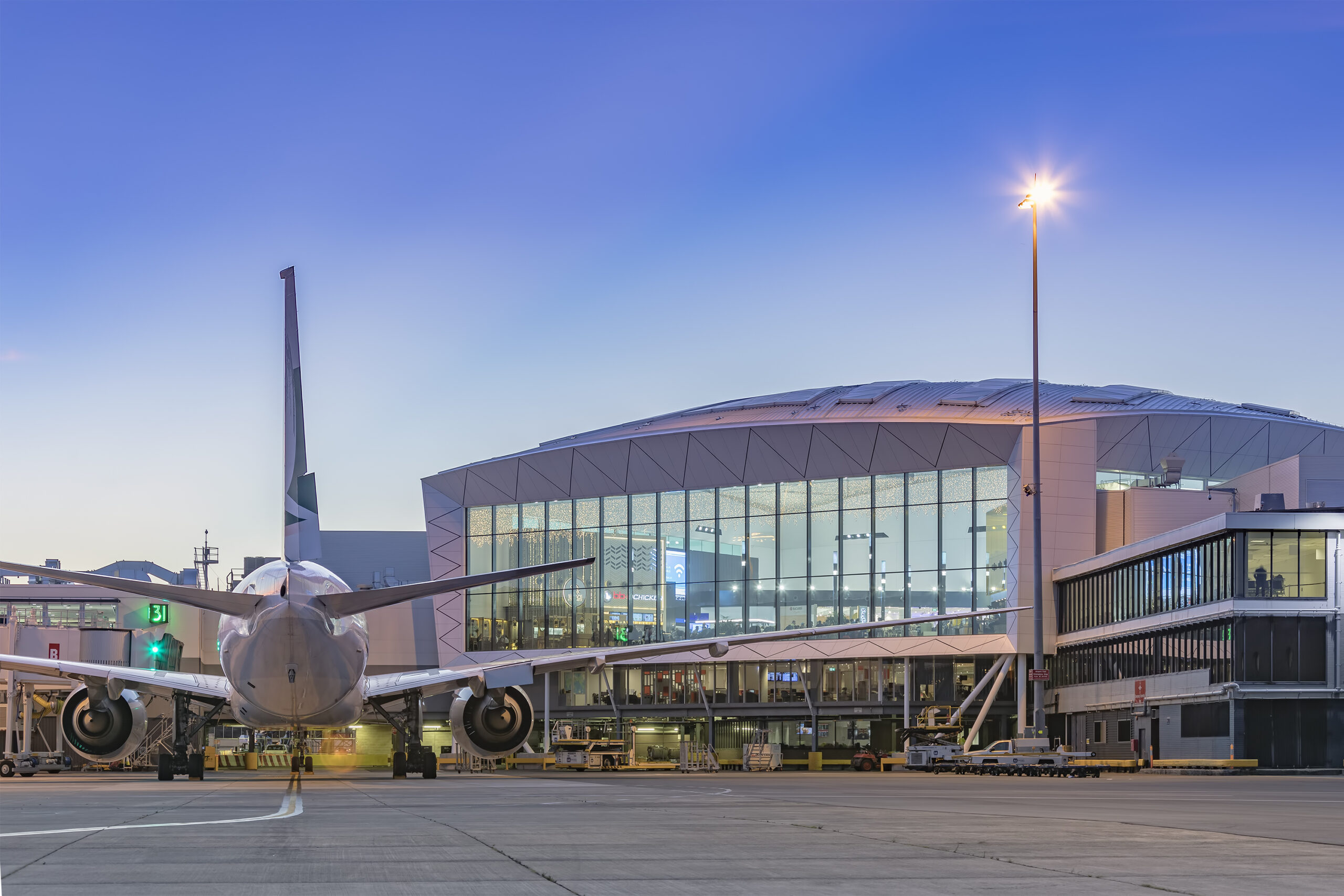 Sydney airport at dusk with an aircraft on the tarmac