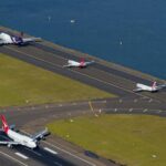 Multiple aircraft’s going down a tarmac at Sydney Airport