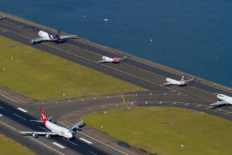 Multiple aircraft’s going down a tarmac at Sydney Airport
