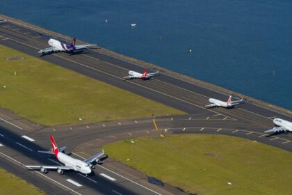 Multiple aircraft’s going down a tarmac at Sydney Airport