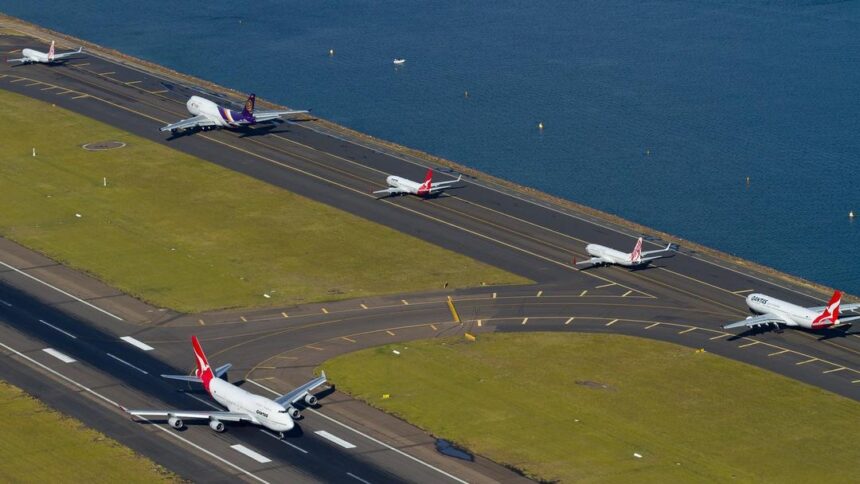 Multiple aircraft’s going down a tarmac at Sydney Airport