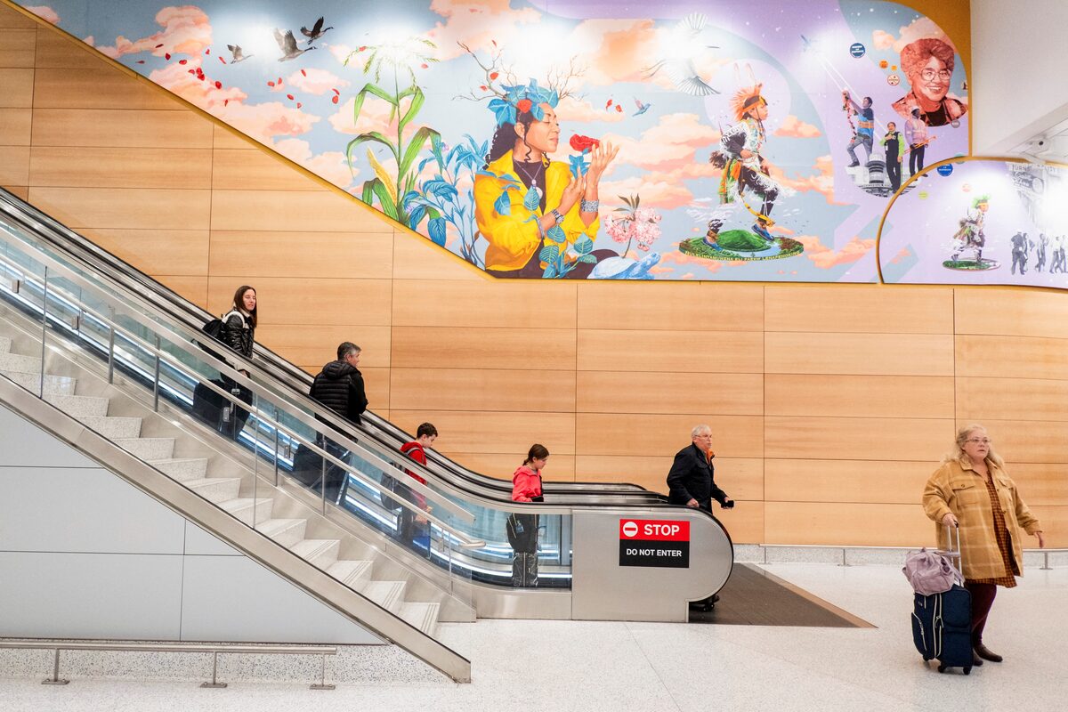 People on an escalator at EWR