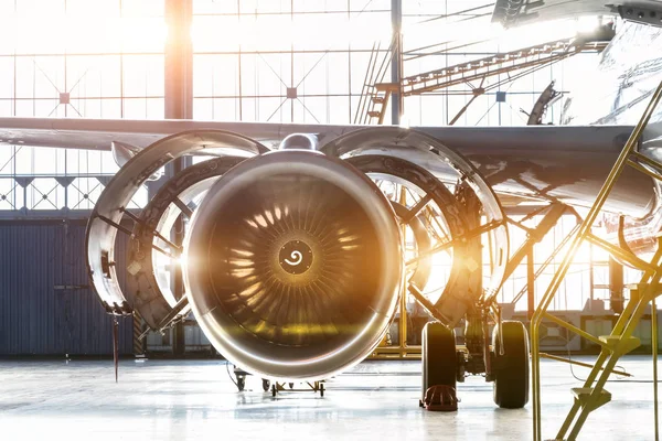 The image of opened hood airplane engine jet under maintenance in the hangar.