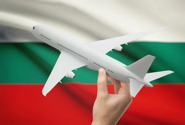 The image of the airplane in hand with national flag on background - Bulgaria.