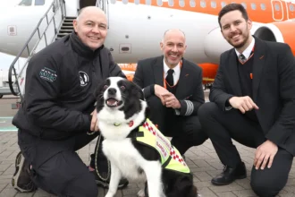 3 men and a SARDA IN search and rescue dog in front of an easyJet plane
