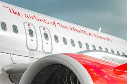 Red and white Air Malta aircraft with writing "The airline of the Maltese islands"