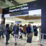Passengers pass through airport departures