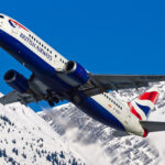 A British Airways 737 plane flying over snowy terrain. Direct flights from London Heathrow to Tromsø are now available.