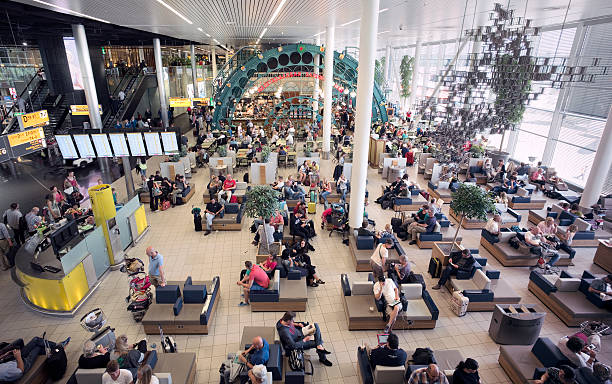 Travelers waiting for departure at one of the lounges (Schengen area) at Schiphol Airport, Amsterdam, The Netherlands.