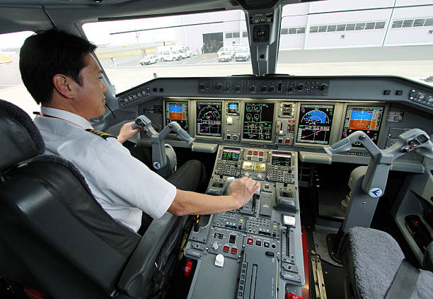A Japan Airline’s pilot in the cockpit of an aircraft. 