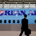 A man walks next to the logo of Korean Air airlines during an organised media tour, at the company's Cabin Crew Training Center in Seoul, South Korea, June 27, 2024.
